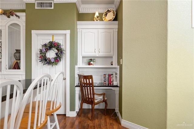 interior space with ornamental molding and dark hardwood / wood-style floors