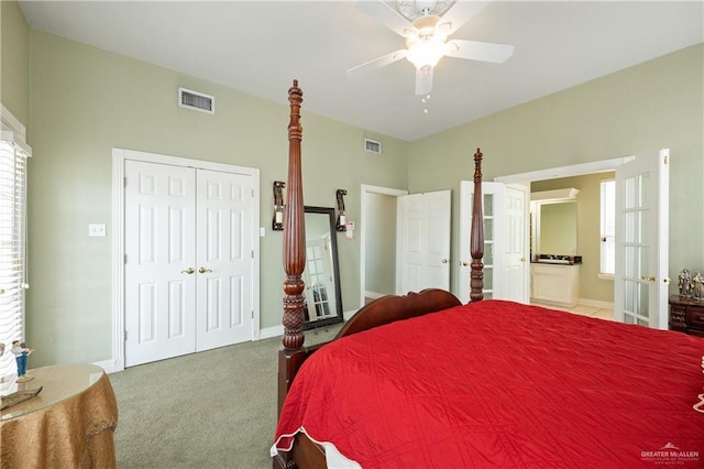 bedroom featuring ensuite bathroom, carpet flooring, ceiling fan, and a closet