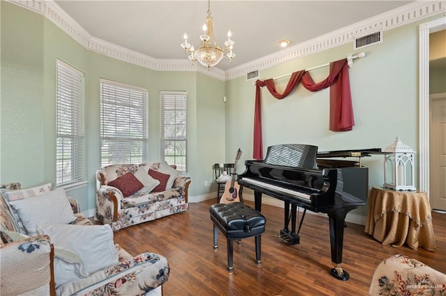 living area featuring crown molding, a chandelier, and dark hardwood / wood-style flooring