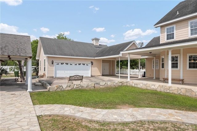 view of front of house featuring a garage, a front yard, and a porch