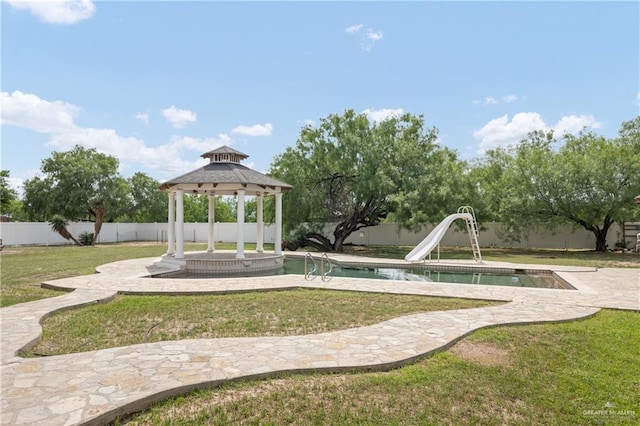 view of swimming pool featuring a gazebo, a water slide, and a yard