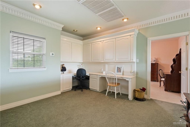 home office featuring built in desk and light colored carpet