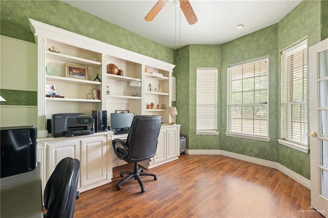 home office with ceiling fan and dark hardwood / wood-style flooring