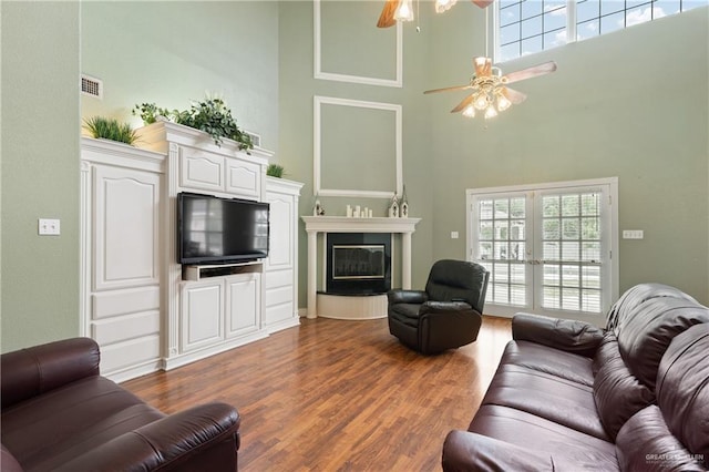 living room featuring plenty of natural light, dark hardwood / wood-style floors, and french doors