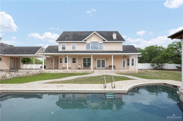 rear view of house with french doors, a yard, and a patio area