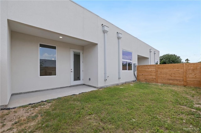 1216 N Lincoln Ave, San Juan, TX 78589 - back of property with stucco siding and a patio area