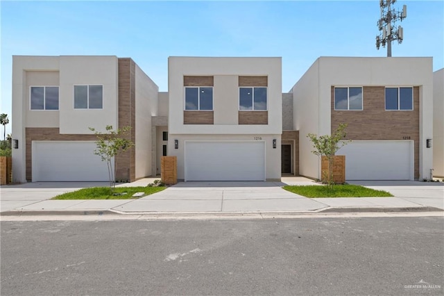 1216 N Lincoln Ave, San Juan, TX 78589 - contemporary home featuring an attached garage, driveway, and stucco siding