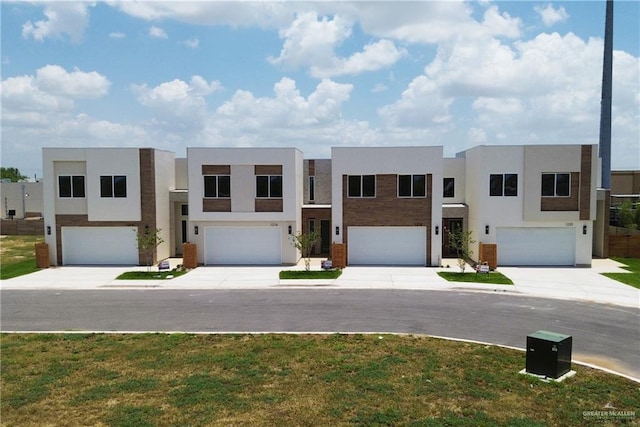1216 N Lincoln Ave, San Juan, TX 78589 - modern home with stucco siding, a garage, and a front yard