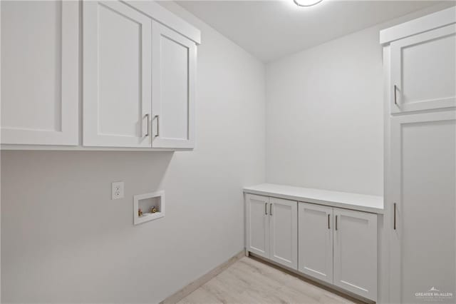1216 N Lincoln Ave, San Juan, TX 78589 - washroom with cabinet space, hookup for a washing machine, light wood-style floors, and baseboards