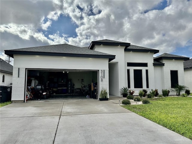 3108 E Kennedy Ave, Alton, TX 78573 - prairie-style home with a front yard, a garage, concrete driveway, a shingled roof, and stucco siding