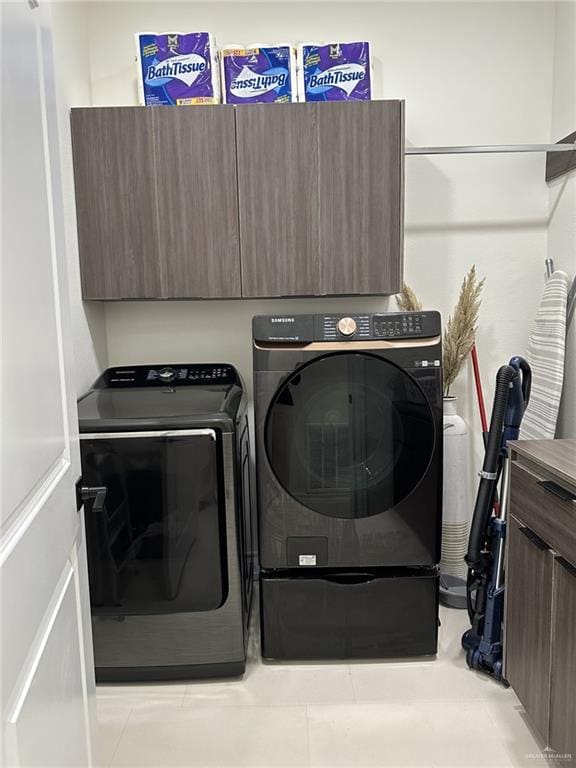 laundry area featuring light tile patterned floors and separate washer and dryer