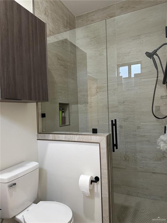 3108 E Kennedy Ave, Alton, TX 78573 - full bathroom with toilet and a stall shower