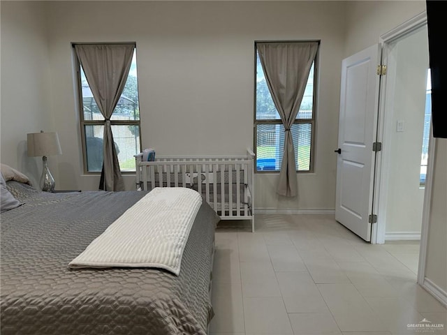 3108 E Kennedy Ave, Alton, TX 78573 - bedroom with baseboards, multiple windows, and tile patterned flooring