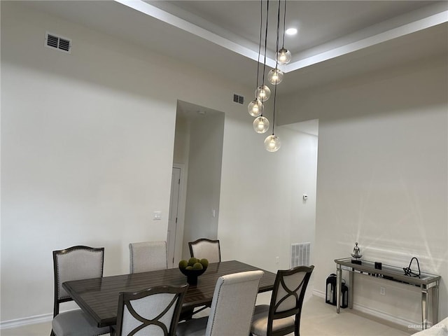 dining room featuring a raised ceiling