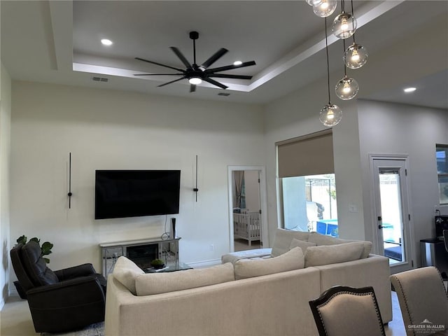 3108 E Kennedy Ave, Alton, TX 78573 - living room with a ceiling fan, a raised ceiling, a high ceiling, and recessed lighting