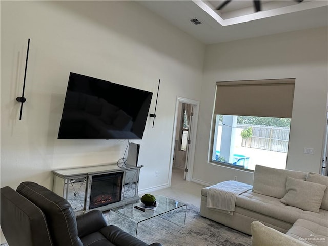 3108 E Kennedy Ave, Alton, TX 78573 - carpeted living area featuring a glass covered fireplace and baseboards