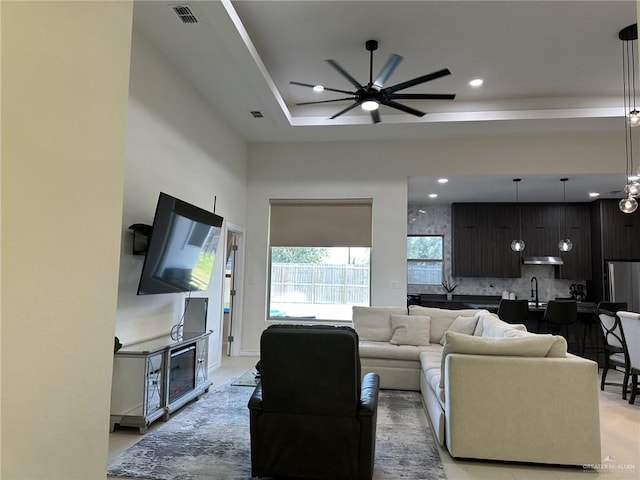 3108 E Kennedy Ave, Alton, TX 78573 - living room with ceiling fan, a raised ceiling, and recessed lighting