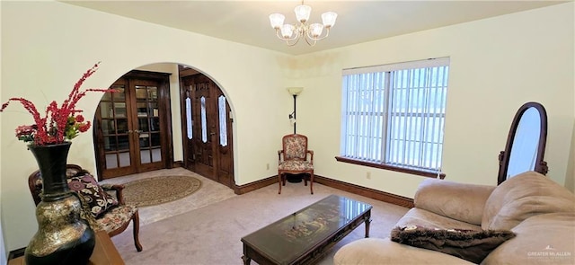 interior space featuring baseboards, arched walkways, and a notable chandelier