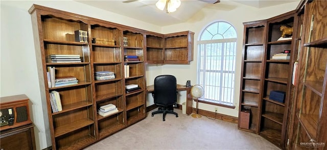 home office with a ceiling fan, light carpet, and baseboards