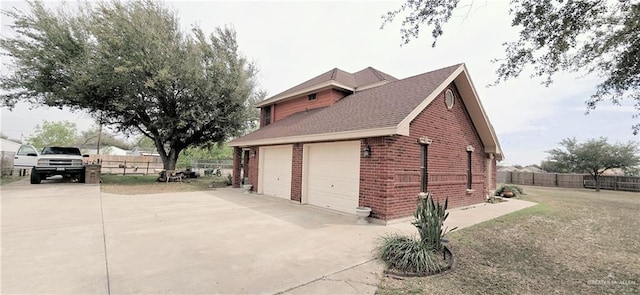 view of home's exterior featuring a garage, brick siding, driveway, and fence