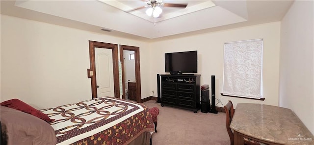 bedroom featuring carpet, visible vents, a tray ceiling, and baseboards