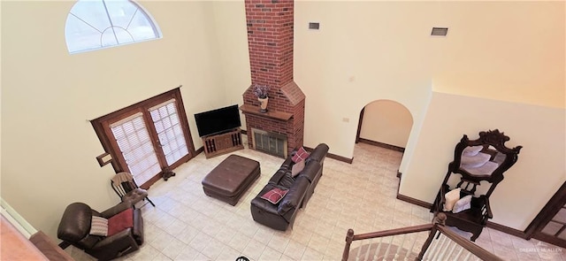 living room featuring a fireplace, visible vents, and baseboards