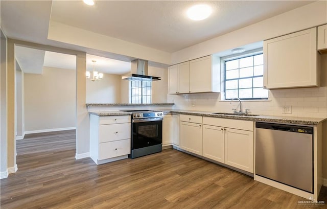 kitchen with dark wood-type flooring, sink, appliances with stainless steel finishes, white cabinetry, and extractor fan