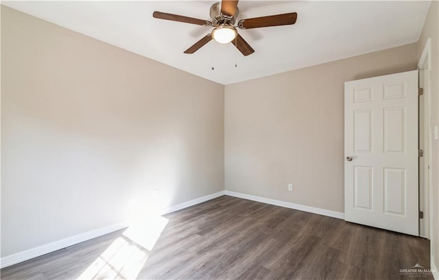 spare room featuring dark hardwood / wood-style floors and ceiling fan