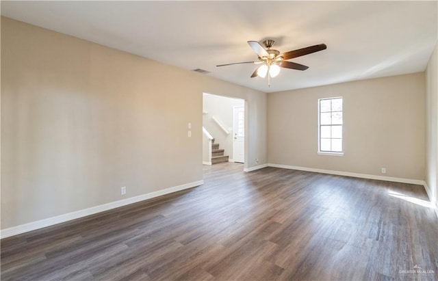 unfurnished room featuring ceiling fan and dark hardwood / wood-style flooring