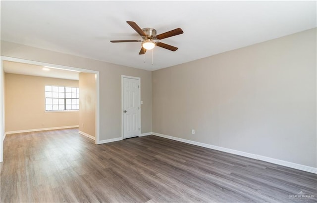 unfurnished room featuring dark hardwood / wood-style floors and ceiling fan