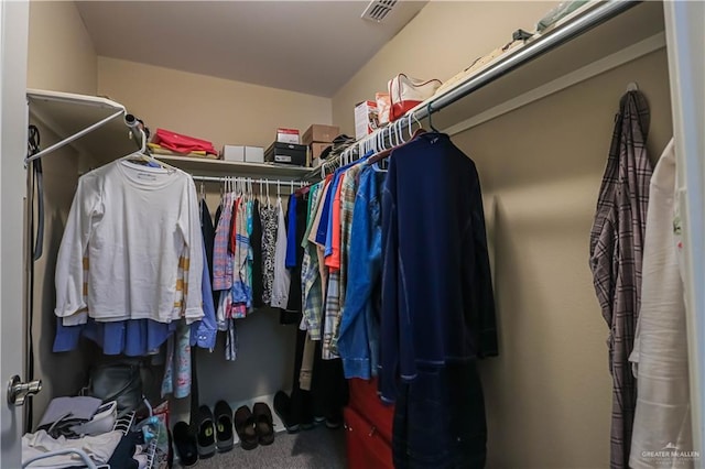 walk in closet featuring carpet floors