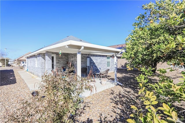 back of property with a patio