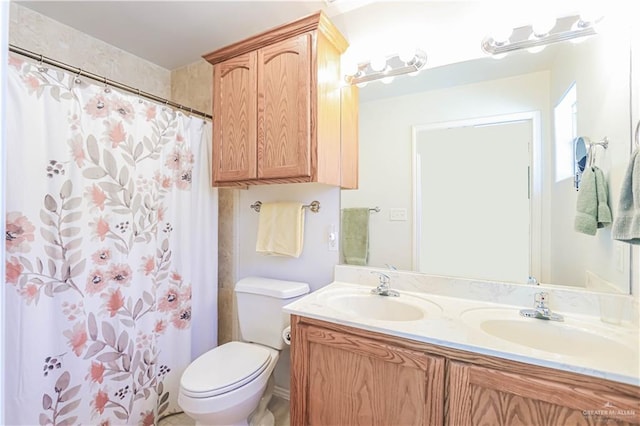 bathroom featuring vanity, a shower with shower curtain, and toilet