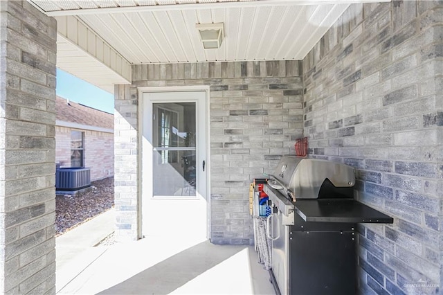 view of patio with cooling unit and grilling area