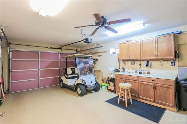 garage with ceiling fan and a garage door opener