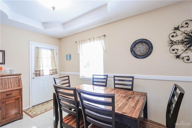 dining room featuring a raised ceiling