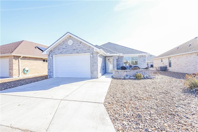 ranch-style house featuring cooling unit and a garage