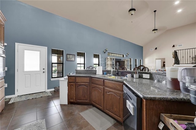 5213 Mile 8 1/2 Rd, Edinburg, TX 78541 - kitchen with stainless steel appliances, high vaulted ceiling, dark tile patterned flooring, open floor plan, and dark stone countertops
