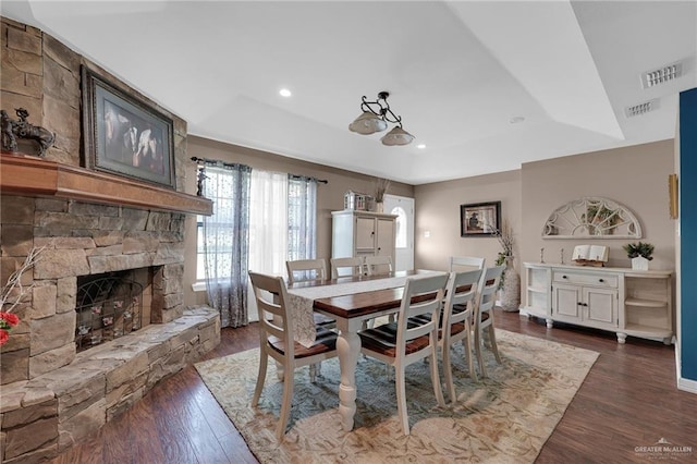 5213 Mile 8 1/2 Rd, Edinburg, TX 78541 - dining area featuring a tray ceiling, dark wood finished floors, a fireplace, and recessed lighting