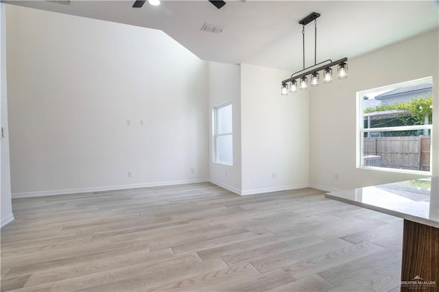 unfurnished dining area with ceiling fan and light hardwood / wood-style floors