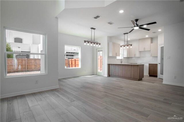 2310 Corales St, Mission, TX 78573 - unfurnished living room with light wood-style flooring, a ceiling fan, recessed lighting, baseboards, and a sink