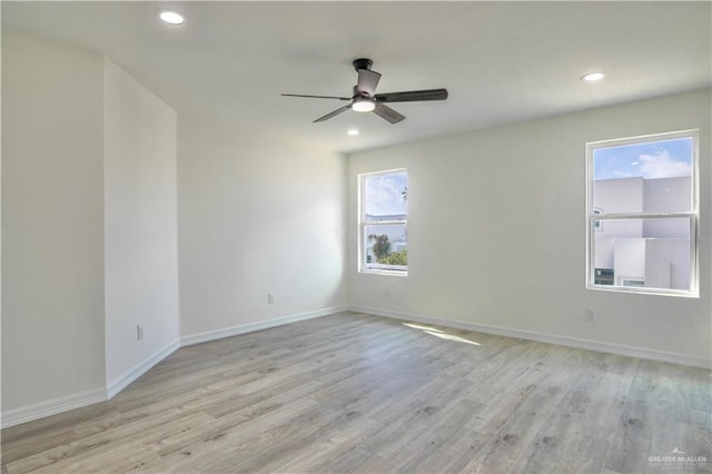 spare room with ceiling fan and light hardwood / wood-style floors