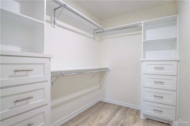 walk in closet featuring light hardwood / wood-style flooring