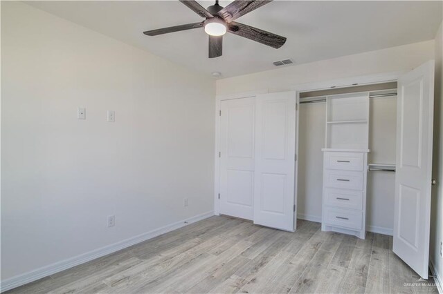 2310 Corales St, Mission, TX 78573 - unfurnished bedroom with light wood-style floors, a closet, baseboards, and ceiling fan