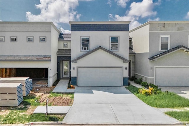 2310 Corales St, Mission, TX 78573 - view of front of home with stucco siding, a garage, driveway, and a tiled roof