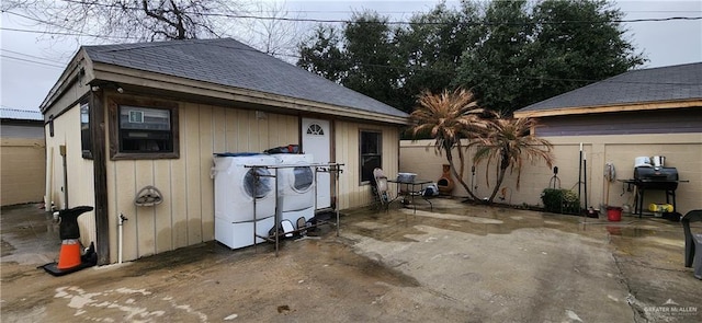 view of outbuilding featuring fence