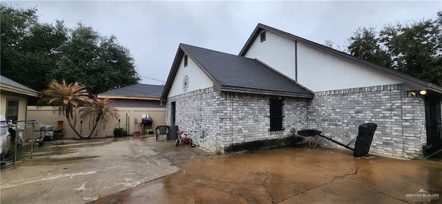 view of home's exterior featuring a patio area and fence