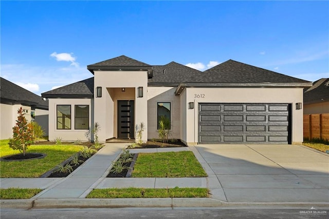 view of front of house featuring a front lawn and a garage