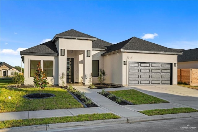 view of front of property with a front lawn and a garage