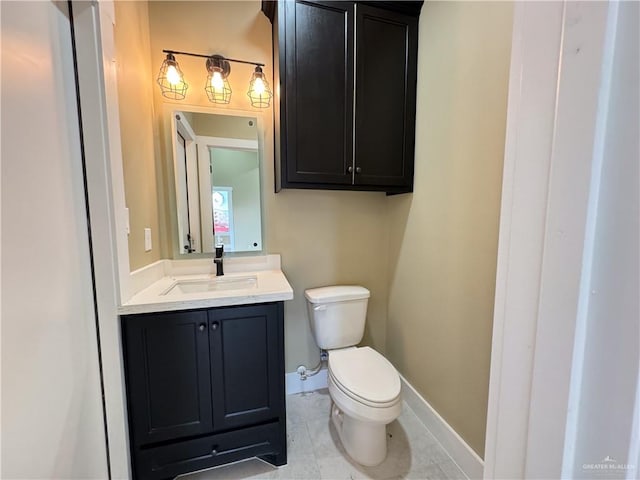 bathroom with tile patterned flooring, vanity, and toilet